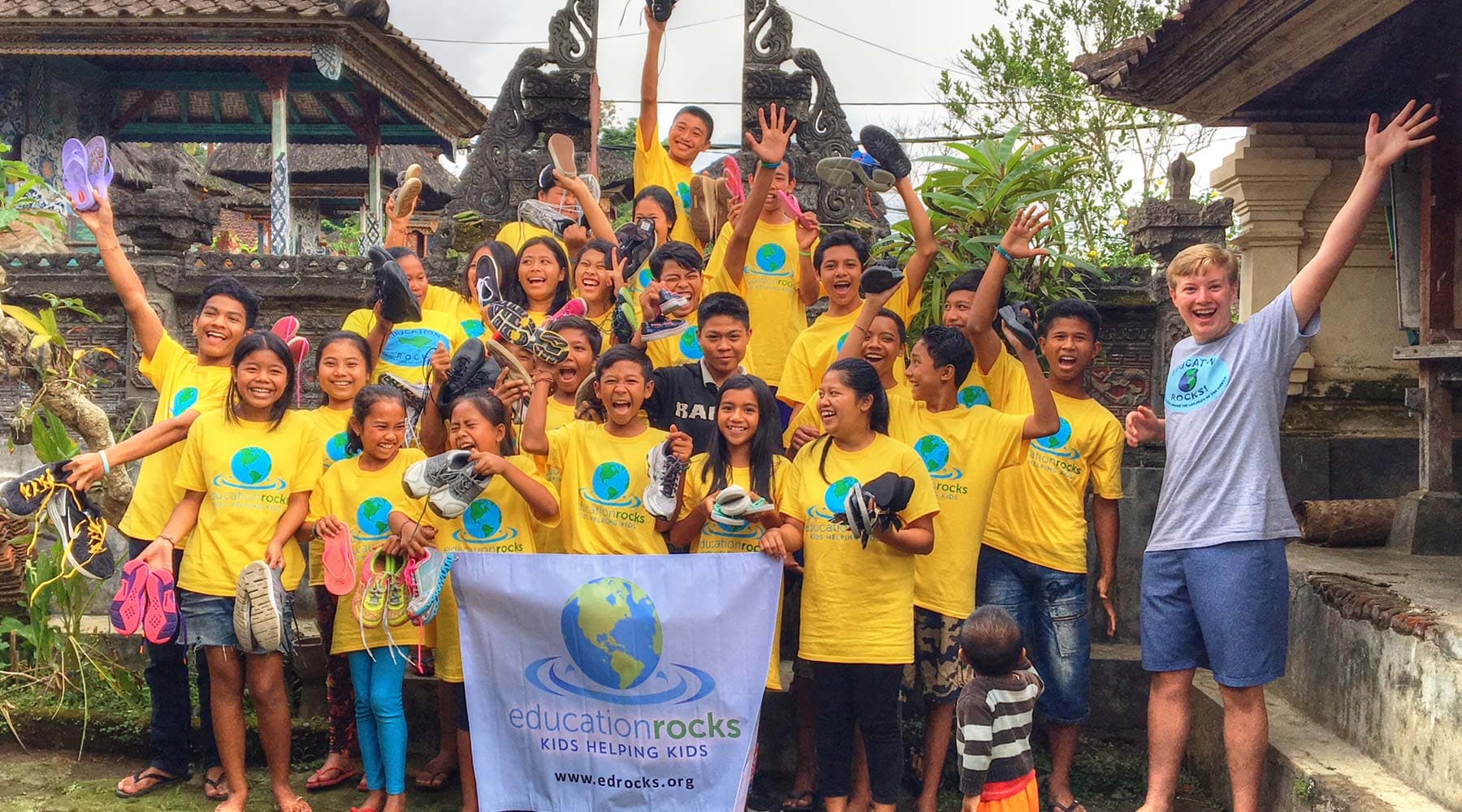 Children receiving donated shoes